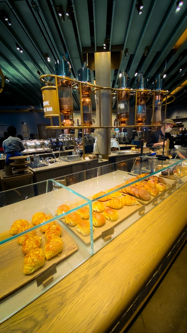 pastries under glass in an industrial style Starbuck coffee house