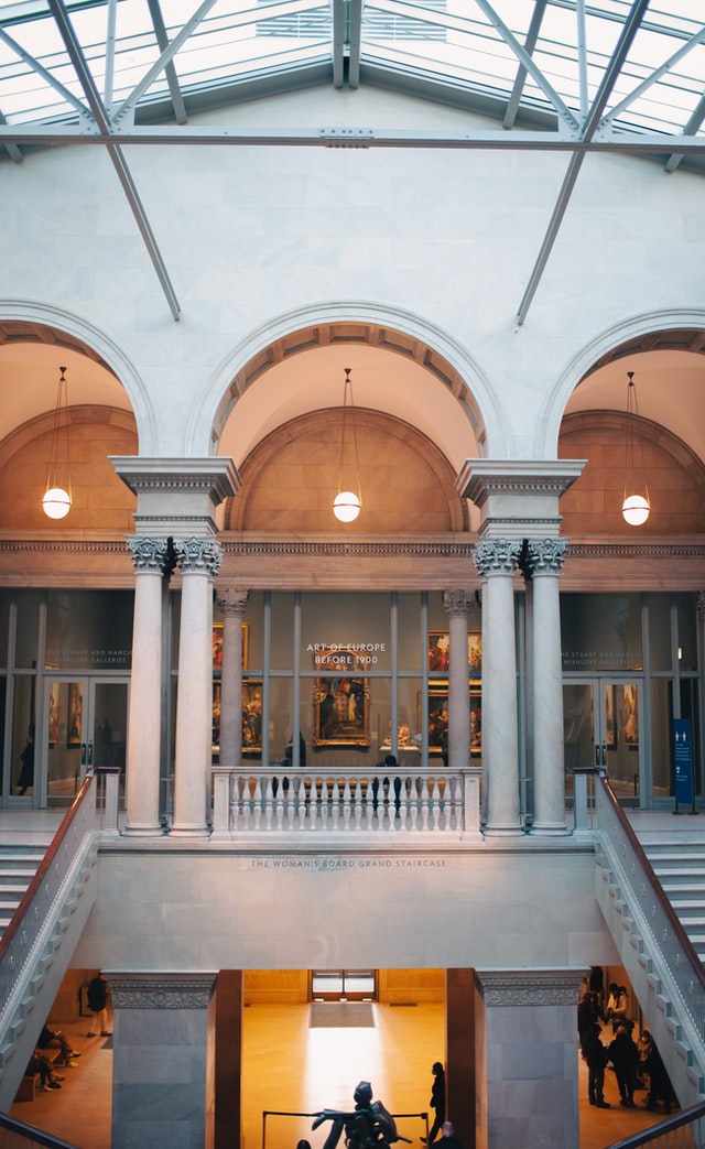 Grand staircase, Corinthian columns, and beautiful arches inside an art museum